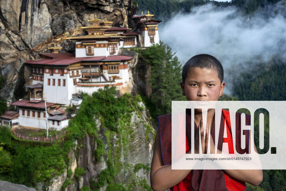 Monk in the Taktsang Goemba or Tigers nest monastery in Paro valley, Bhutan, Asia. Paro Taktsang or Taktsang Palphug Monastery and the Tiger s Nest is a prominent Himalayan Buddhist sacred site and the temple complex is located in the cliffside of the upper Paro valley in Bhutan. A temple complex was first built in 1692, around the Taktsang Senge Samdup cave where Guru Padmasambhava is said to have meditated for three years, three months, three weeks, three days and three hours in the 8th century. Bhutan