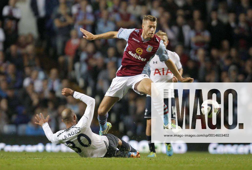 Nathan Baker of Aston Villa hurdles a challenge from Sandro of Tottenham - Football - Capital One Cup - Aston Villa vs Tottenham Hotspur - Villa Park Birmingham - Season 2013-2014 - September 24th 2013 - Photograph Malcolm Couzens Sportimage .