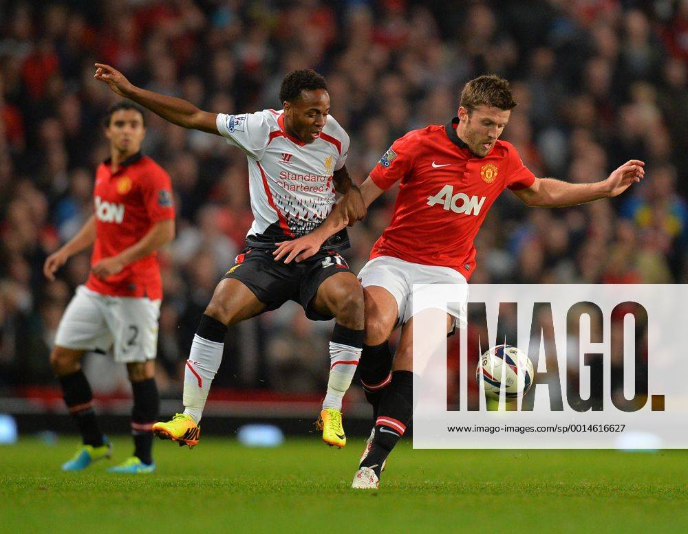 Raheem Sterling of Liverpool tussles with Michael Carrick of Manchester United - Capital One Cup - Third Round - Manchester United, ManU - FC Liverpool. Old Trafford Stadium - Manchester - 25 09 13 - PicturexSimon BellisxSportimage .