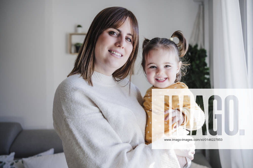 Woman carrying happy baby girl at home model released property released, EBBF05096