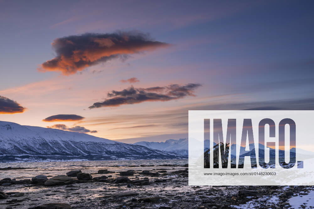 Shipwreck lying on shore of secluded Fjord at winter dawn, RUEF03447