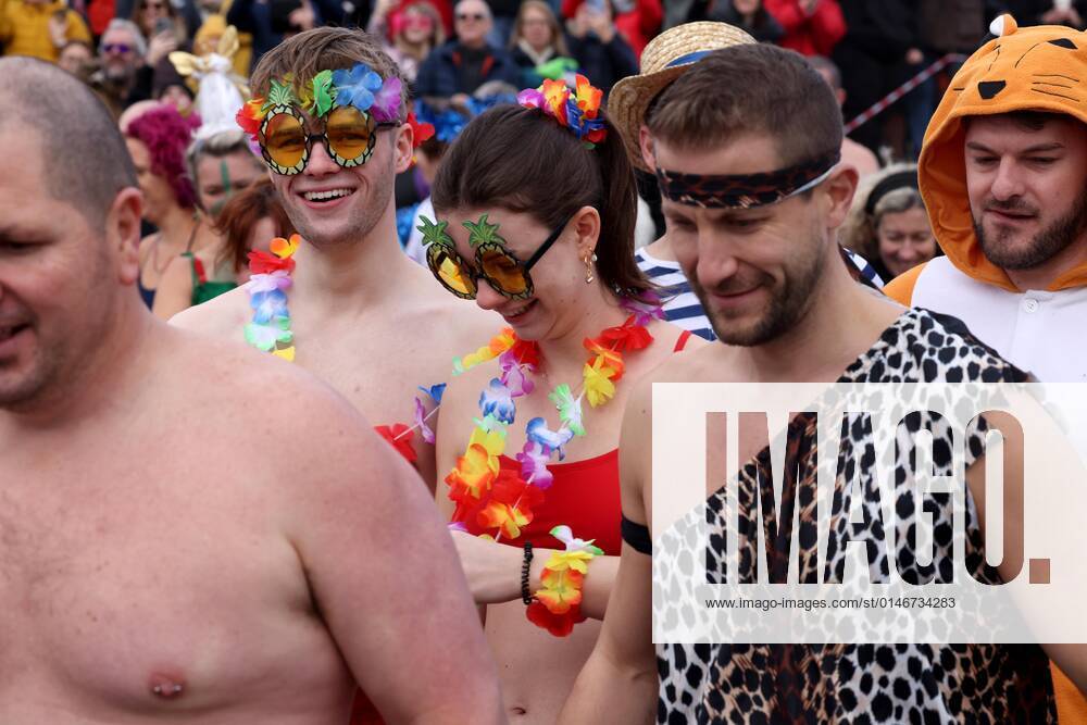 Over 350 New Year revellers, many in fancy dress, take part in the New Year Big Dip at East Wittering Beach in Chichester, West Sussex. More than double the previous record number of people took part, making the most of the warmest New YearÕs Day on record in the UK. JANUARY 1st 2022 MTXx2201
