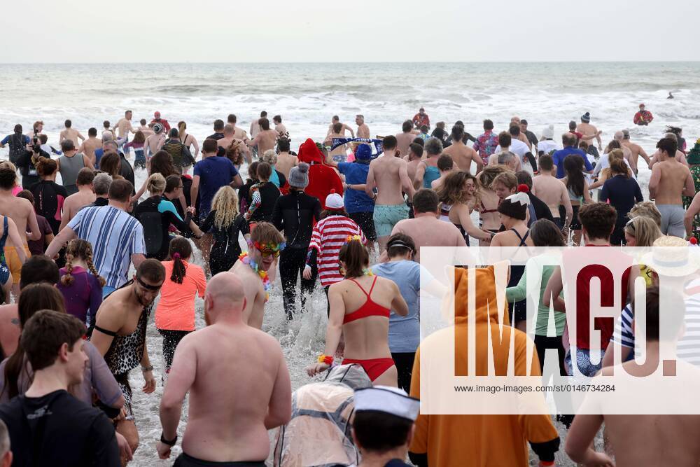 Over 350 New Year revellers, many in fancy dress, take part in the New Year Big Dip at East Wittering Beach in Chichester, West Sussex. More than double the previous record number of people took part, making the most of the warmest New YearÕs Day on record in the UK. JANUARY 1st 2022 MTXx2201
