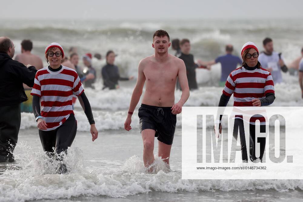 Over 350 New Year revellers, many in fancy dress, take part in the New Year Big Dip at East Wittering Beach in Chichester, West Sussex. More than double the previous record number of people took part, making the most of the warmest New YearÕs Day on record in the UK. JANUARY 1st 2022 MTXx2201