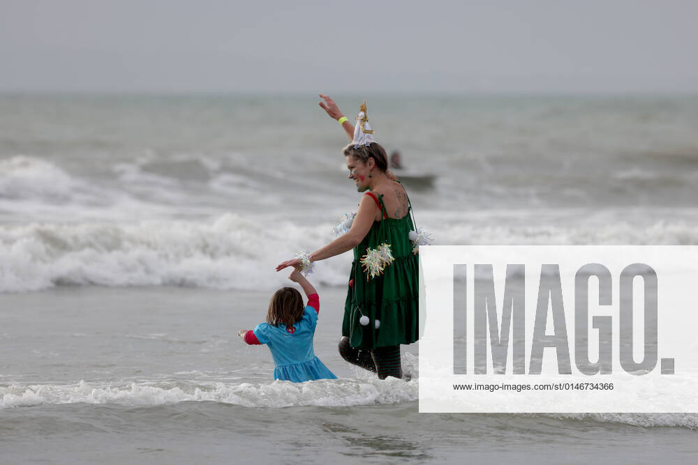 Over 350 New Year revellers, many in fancy dress, take part in the New Year Big Dip at East Wittering Beach in Chichester, West Sussex. More than double the previous record number of people took part, making the most of the warmest New YearÕs Day on record in the UK. JANUARY 1st 2022 MTXx2201