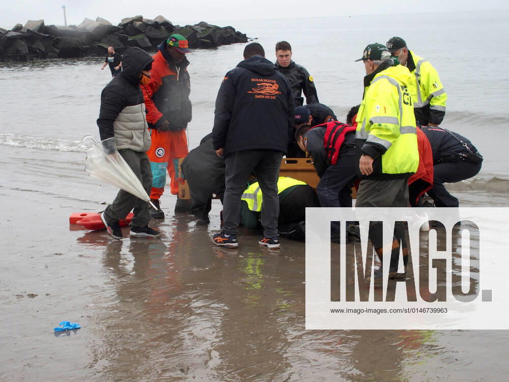 January 1, 2022 New York , Coney Island Polar Bear Plunge. This year the Polar Bear Plunge returned after last year s Covid outbreak. Revelers enjoy the water..Participant prior to massive cardiac event and Emergency medical personnel try and revive him before transporting him to area hospital. New York USA - ZUMAct2_ 20220101_zaf_ct2_087