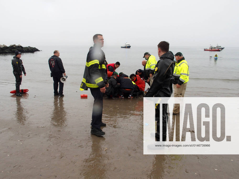 January 1, 2022 New York , Coney Island Polar Bear Plunge. This year the Polar Bear Plunge returned after last year s Covid outbreak. Revelers enjoy the water..Participant prior to massive cardiac event and Emergency medical personnel try and revive him before transporting him to area hospital. New York USA - ZUMAct2_ 20220101_zaf_ct2_090