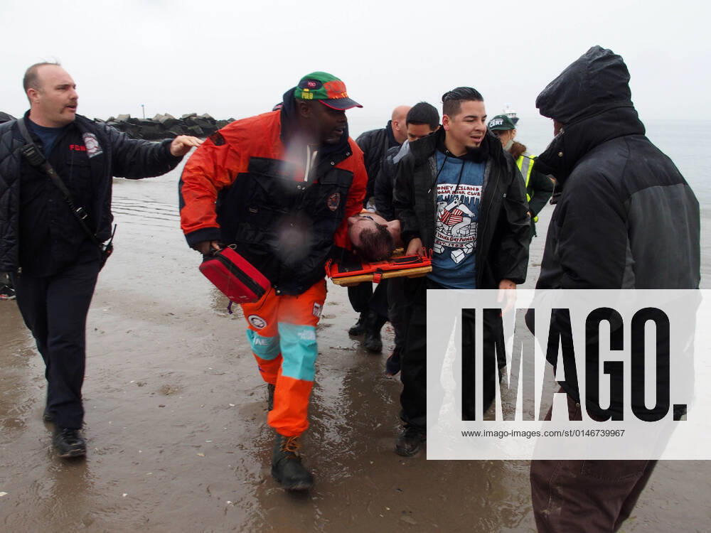 January 1, 2022 New York , Coney Island Polar Bear Plunge. This year the Polar Bear Plunge returned after last year s Covid outbreak. Revelers enjoy the water..Participant prior to massive cardiac event and Emergency medical personnel try and revive him before transporting him to area hospital. New York USA - ZUMAct2_ 20220101_zaf_ct2_091