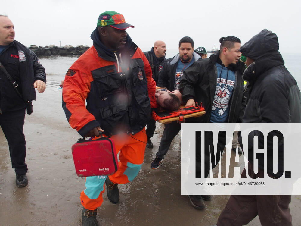 January 1, 2022 New York , Coney Island Polar Bear Plunge. This year the Polar Bear Plunge returned after last year s Covid outbreak. Revelers enjoy the water..Participant prior to massive cardiac event and Emergency medical personnel try and revive him before transporting him to area hospital. New York USA - ZUMAct2_ 20220101_zaf_ct2_092