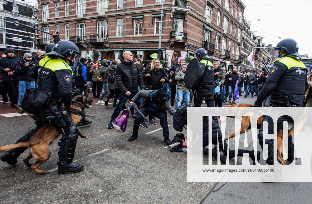 Undercover police officers, and riot police, confront two protesters, one with a weapon, as he tries to assists a fellow protester the during theanti-covid-19 demonstration..The first main anti-covid 19 demonstration of the year. At least thirty arrests on the Museumplein, and four officers injured. The city council, the Public Prosecution Service and the police, banned the demonstration as there were signs that some protesters would attend with weapons and were bent on violence. The situation got out of hand, when the demonstrators attempted to leave the vicinity of Museumplein, as they were boxed-in, on the Paulus Potterstraat, by a line of riot police, water cannon, canine units and - ZUMAs197 20220102_zaa_s197_122