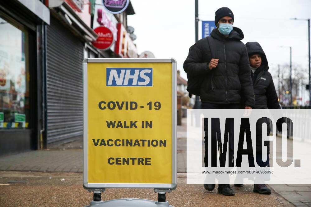 People seen walking past a Covid -19 vaccination sign. London United Kingdom - ZUMAs197 20220108_zab_s197_025