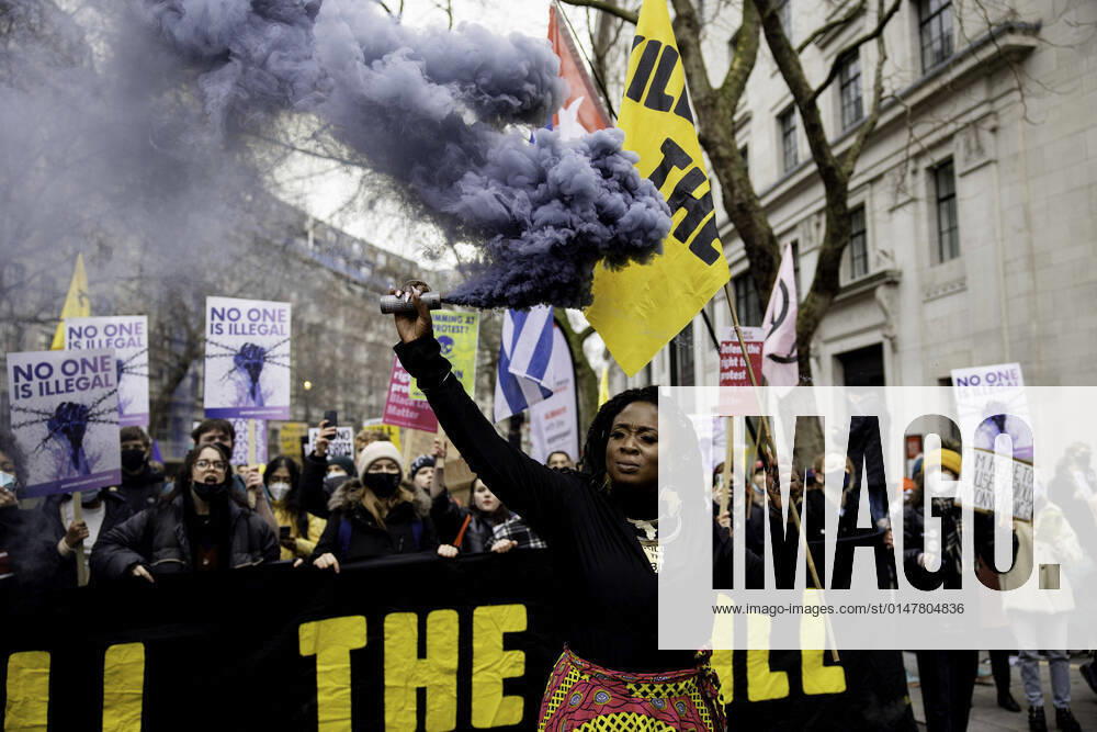 An activist holds a smoke bomb during the demonstration..Thousands of activists in London responded to the national call of actions and marched down the streets to protest against the Police, Crime, Sentencing and Courts Bill. The bill proposes to increase the power for police to stop protests from happening and is currently being debated in the House of Lords. London United Kingdom - ZUMAs197 20220115_zaa_s197_207
