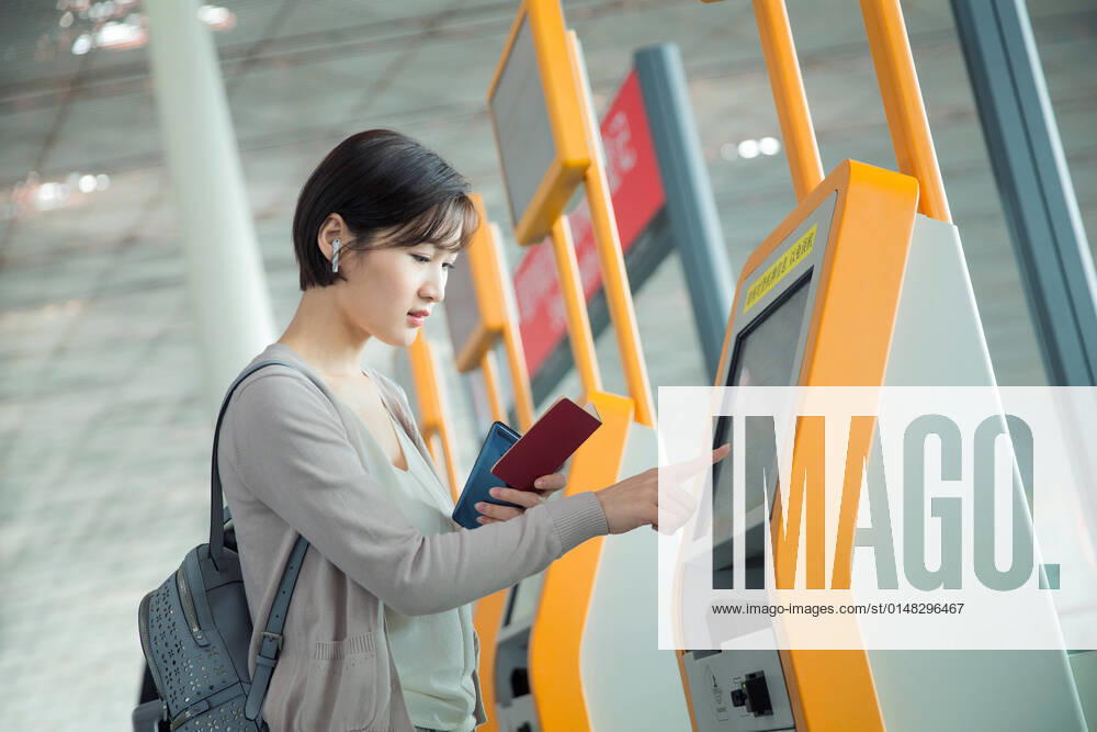 Business lady in the airport to use automatic machines China, 12 04 2019, model released,