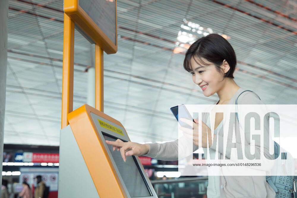 Business lady in the airport to use automatic machines China, 12 04 2019, model released,