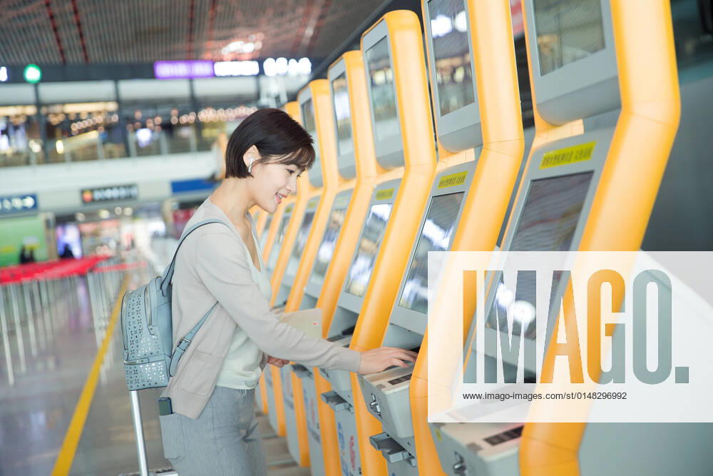 Business lady in the airport to use automatic machines China, 12 04 2019, model released,