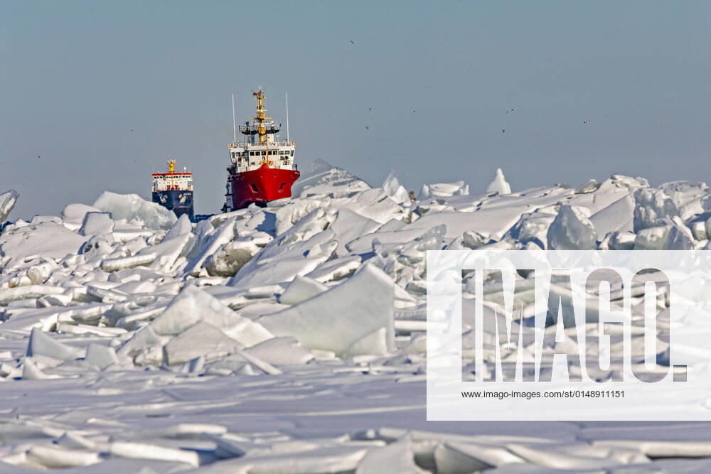 Detroit, Michigan USA - 26 January 2022 - The Canadian Coast Guard vessel Samuel Risley leads the Algocanada, an oil chemical tanker, through ice on Lake St. Clair as they enter the Detroit River. Cold weather in the region has created ice jams and caused shipping problems in some locations, Detroit USA - ZUMAw66_ 20220126_zaf_w66_001