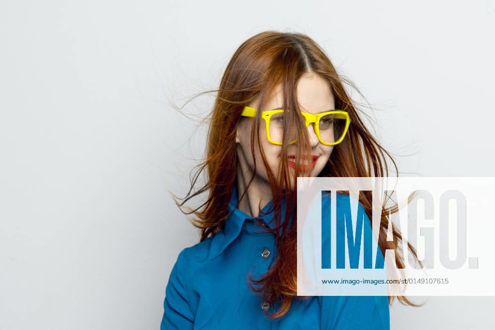 Business woman in blue shirt wearing yellow glasses emotions Business woman in blue shirt wearing yellow glasses emotions. High quality photo