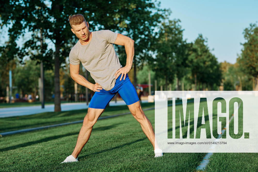 Sporty man in the park on the lawn exercise lifestyle sporty man in the park on the lawn exercise lifestyle. High quality photo