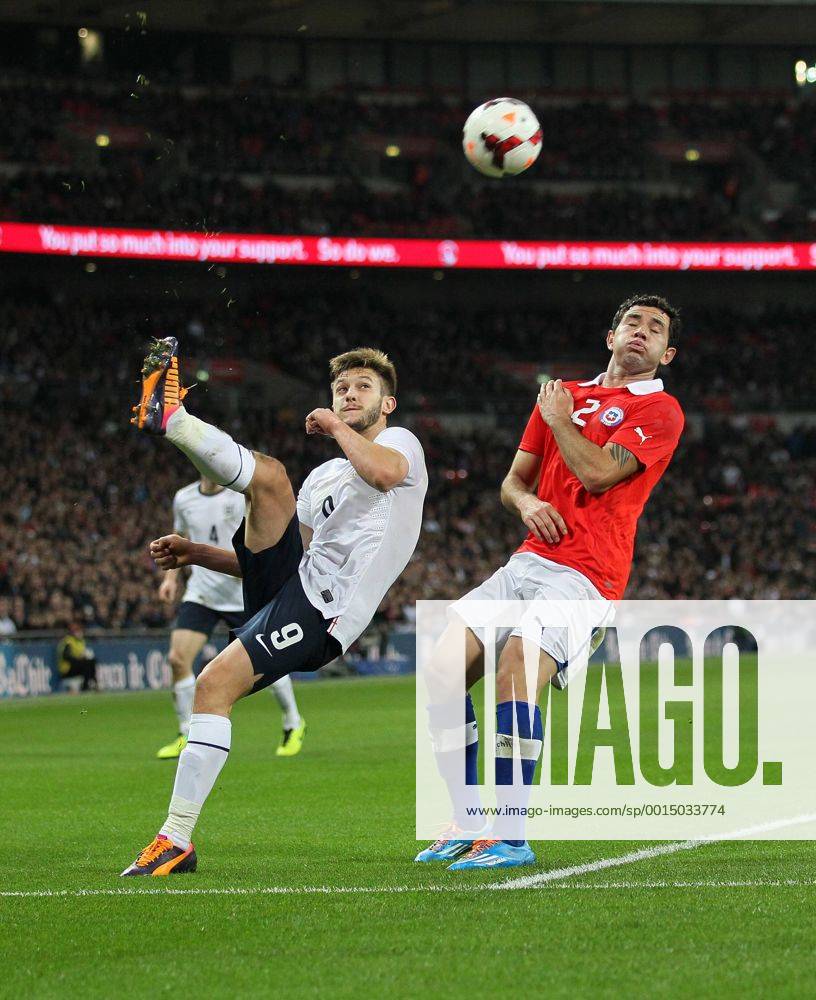 England s Adam Lallana tussles with Chile s Eugenio Mena - England v Chile - International Friendly - Wembley Stadium - London - England -15 11 2013 - Pic David Klein Sportimage .