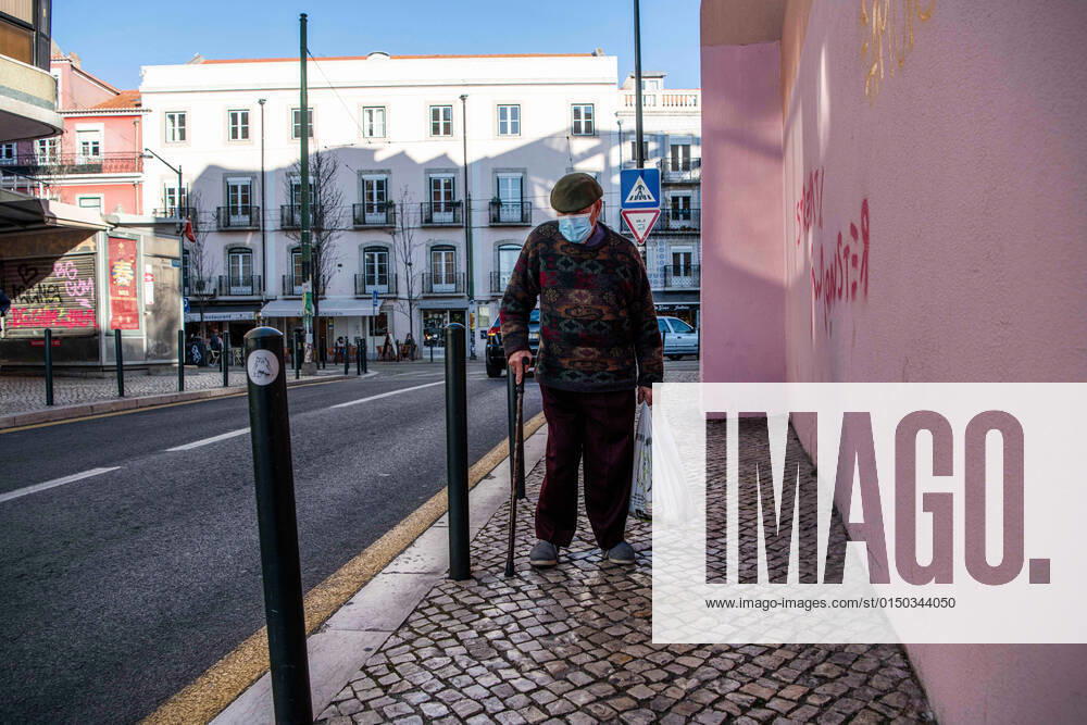 A man wearing a face mask as a preventive measure against the spread of coronavirus walks along the street in the historic neighborhood of Graca, Lisbon. Portugal s official records include a total of 2,915,971 confirmed cases of COVID-19 and 20,222 fatalities since the beginning of the pandemic. Lisbon Portugal - ZUMAs197 20220207_zaa_s197_496
