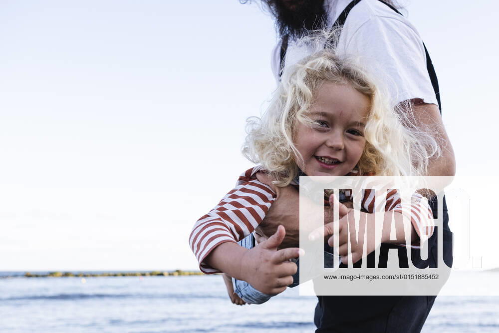Father carrying cute boy playing at beach model released, ASGF02116
