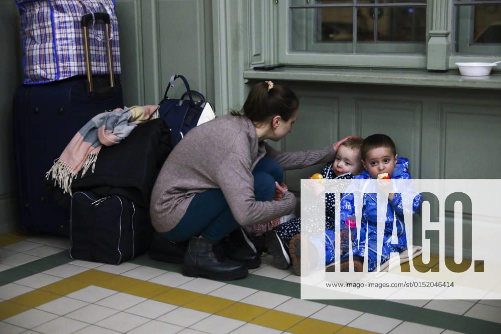 People Arrive In Poland After Fleeing Ukraine A mother with children is resting in a temporary shelter inside a building of the railway station after arriving on a train from Kiev in Ukraine to Przemysl, Poland on February 24, 2022. Russian invasion on Ukraine can cause a mass exodus of refugees to Poland. Przemysl Poland