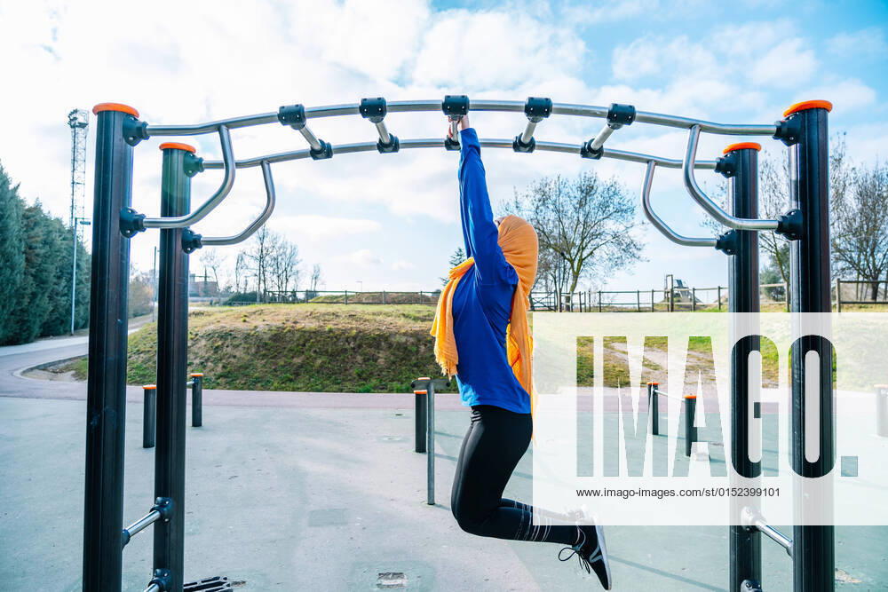 IMAGO Creative: 2022 Sport Favoriten IMAGO Creative: Sport in der Stadt Islamic woman hanging on monkey bar on sports ground Vilafranca del Penedès, Catalonia, Spain CR_SZPTRN220227-935175-01 ,model released, Symbolfoto