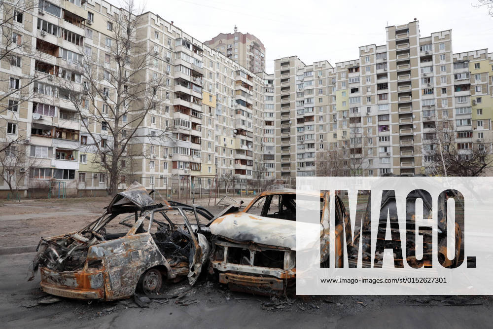 KYIV, UKRAINE - MARCH 07, 2022 - Cars burnt down on February 27th as a result of shelling by the Russian army near a 16-story apartment building on Mykola Lavrukhin Street in Kyiv, capital of Ukraine Yard of high-rise apartment block shelled in Kyiv