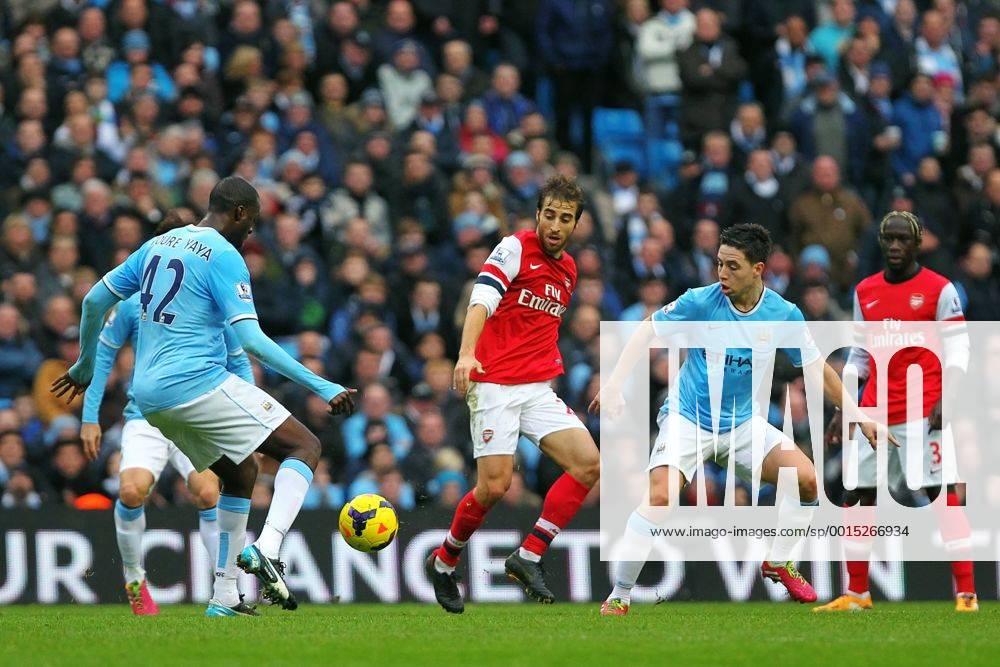Manchester, England. Yaya Toure of Manchester City and Samir Nasri clean up in front of Flamini during the Premier League game between Manchester City and Arsenal from the Etihad Stadium. Keevilx ActionPlus11479234
