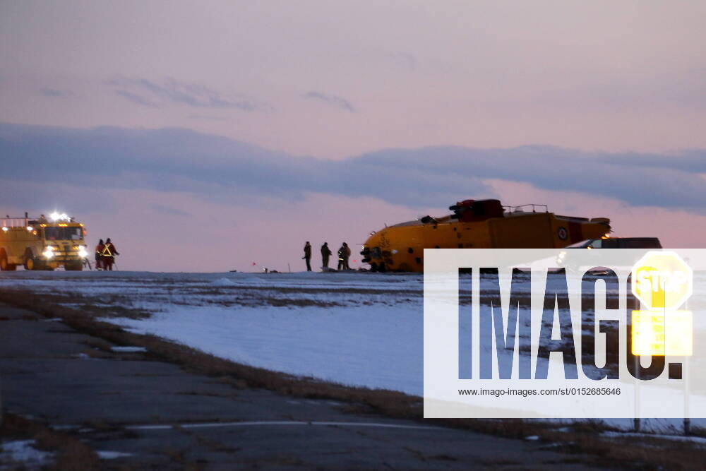 Emergency crews work around the wreckage of a downed CH-149 Cormorant search and rescue helicopter at 9 Wing Canadian Forces Base Gander, in Gander, N.L., Thursday, March 10, 2022. The Royal Canadian Air Force says there were six crew members on board the CH-149 search and rescue helicopter when it went down this afternoon. GANDER CANADA - ZUMAc35_ 20220310_zaf_c35_083