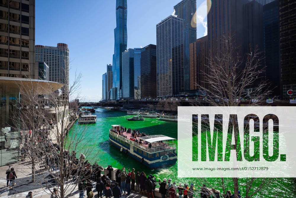 (220312) -- CHICAGO, March 12, 2022 -- People gather on the banks of the Chicago River dyed green in Chicago, the United States, on March 12, 2022. The Chicago River was dyed green on Saturday to celebrate the upcoming St. Patrick s Day, which is marked on March 17. (Photo by Vincent D. Johnson Xinhua) U.S.-CHICAGO-ST. PATRICK S DAY-CELEBRATION XuxJing