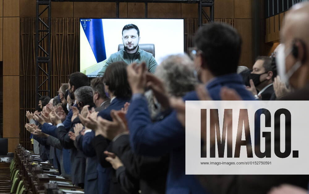 Canadian Members of Parliament and invited guests applaud as Ukrainian President Volodymyr Zelenskyy is shown on a giant video screen before addressing the Canadian parliament, Tuesday, March 15, 2022 in Ottawa. Ottawa Canada - ZUMAc35_ 20220315_zaf_c35_001