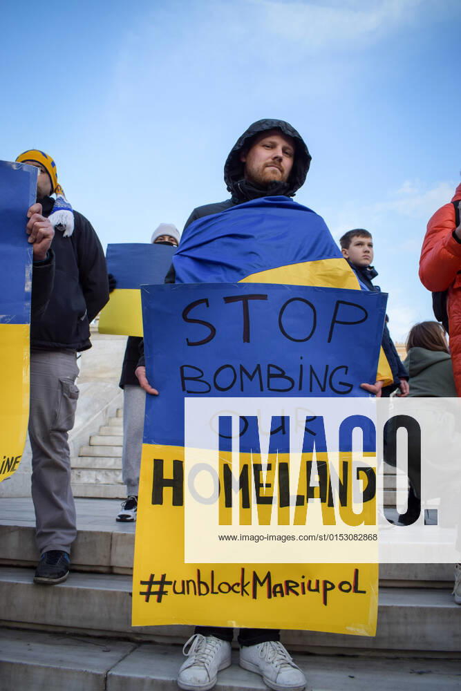 Ukrainian refugees in Greece protest against the Russian invasion of Ukraine Man protests against the Russian invasion of Ukraine, holding placard, at central Syntagma square ahead of the Greek Parliament. Athens Greece