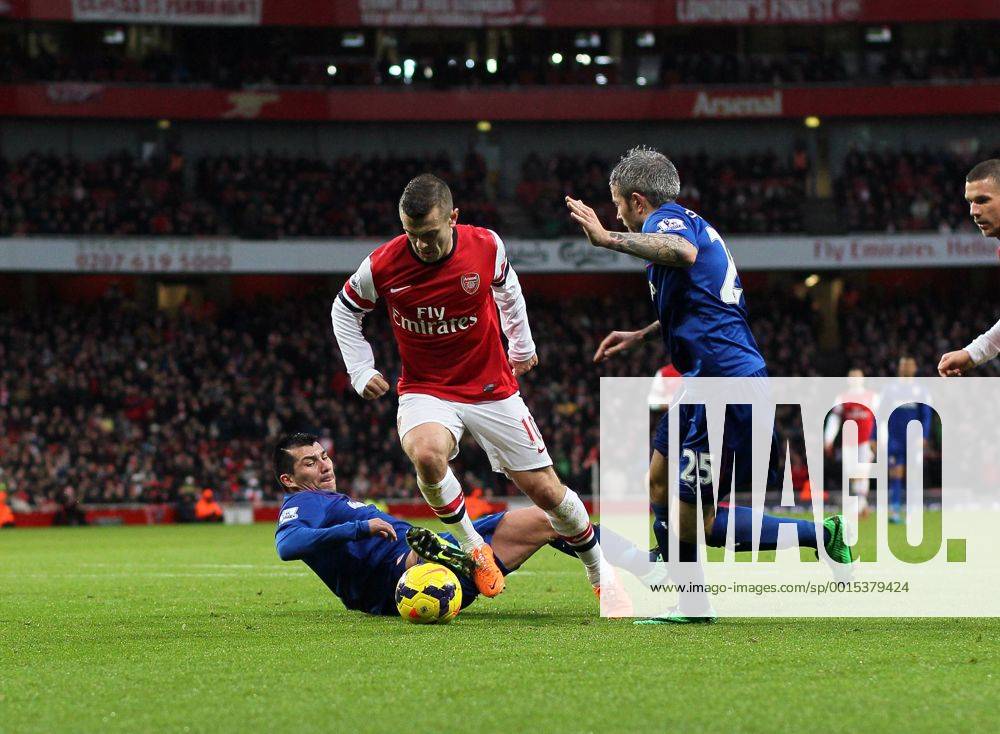 Arsenal s Jack Wilshere gets caught by Cardiff s Gary Medel but no penalty is given Arsenal vs Cardiff - Premier League - Emirates Stadium- London - England - 01 01 2014 - Pic David Klein Sportimage .