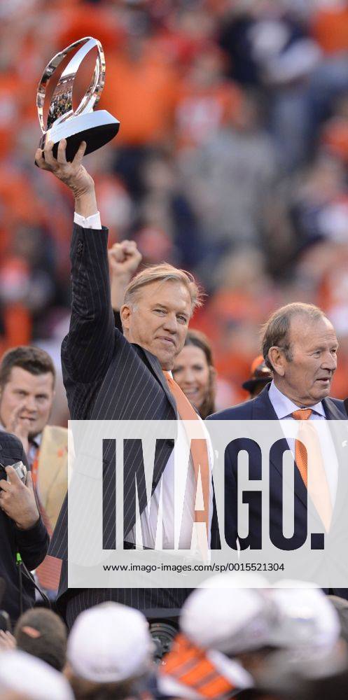 Jan. 18, 2014 - Denver, CO, USA - Broncos executive vice president of football operations John Elway hoists the AFC Championship Trophy at Sports Authority Field at Mile High in Denver on Sunday, Jan. 19, 2014. The Denver Broncos defeated the New England Patriots, 26-16. BRONCOS PATRIOTS - ZUMAm67