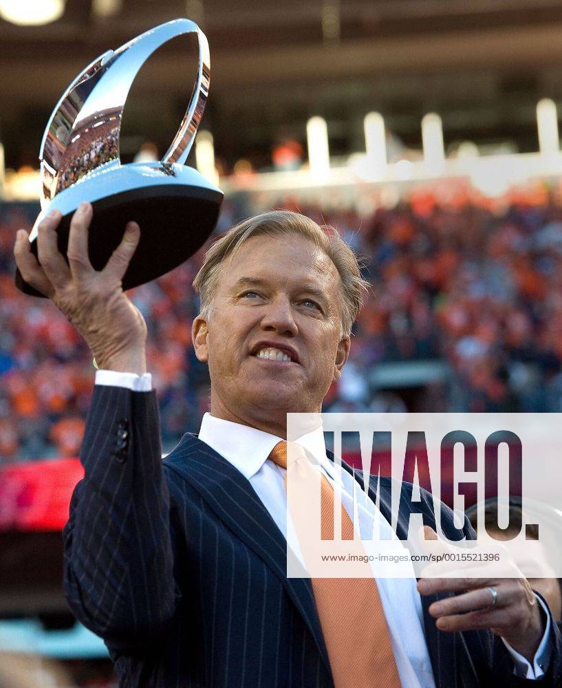 Jan. 18, 2014 - Denver, CO, USA - Broncos executive vice president for football operations John Elway holds the AFC Championship trophy at Sports Authority Field at Mile High in Denver on Sunday, Jan. 19, 2014. The Denver Broncos defeated the New England Patriots, 26-16. BRONCOS PATRIOTS - ZUMAm67