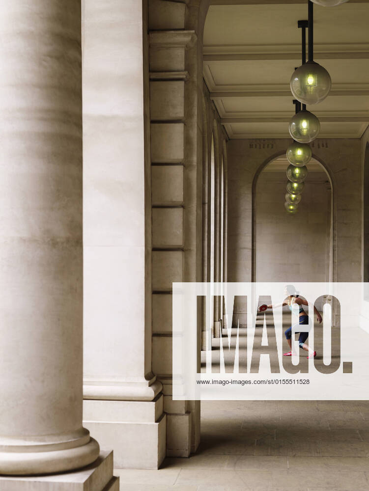 IMAGO Creative: 2022 Sport Favoriten IMAGO Creative: Sport in der Stadt Female Athlete Throwing Discus In Portico, model released, , 10019232.jpg, 2012, 20s, Action, Adult, Arch, Architecture, Athlete, Athletic, Caucasian, Challenge, City, Column, Compete, Competitive, Day, Determination, Determined, Discus, Effort, Energy, Fast, Fitness, Full Length, Hanging, Lamp, Light, London, Olympics, One, Outdoors, Person, Portico, Position, Power, Practicing, Profile, Ready, Side View, Skill, Speed, Sport, Sportswear, Standing, Strength, Strong, Throwing, Training, Vertical, Woman, Young,