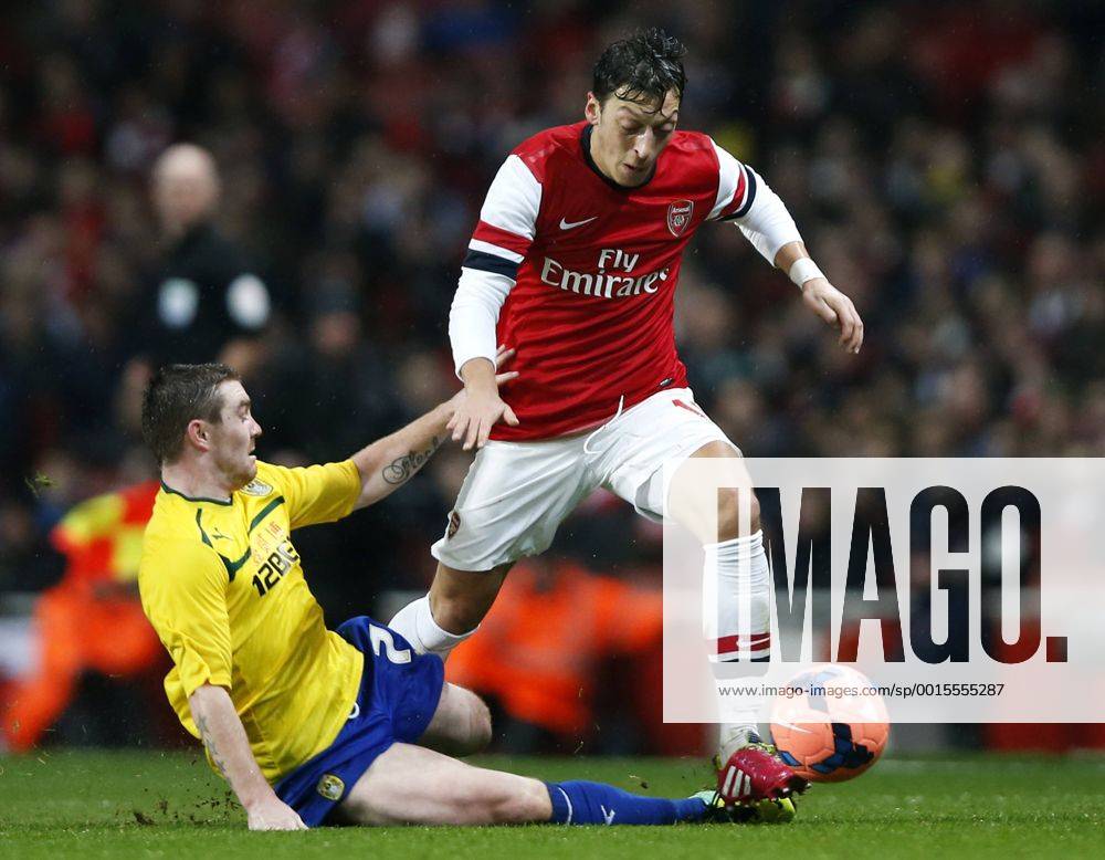 LONDON, Jan. 24, 2014 (Xinhua) -- Mesut Ozil (R) of Arsenal vies with John Fleck of Coventry City during FA Cup Fourth Round match between Arsenal and Coventry City at Emirates Stadium in London, Britain on Jan. 24, 2014.