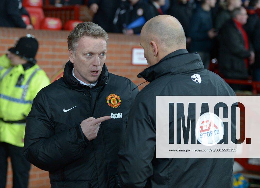 David Moyes manager of Manchester United talks to fourth official Howard Webb - Barclays Premier League - Manchester United (ManU) vs Cardiff City - Old Trafford Stadium - Manchester - England - 28th January 2014 - .