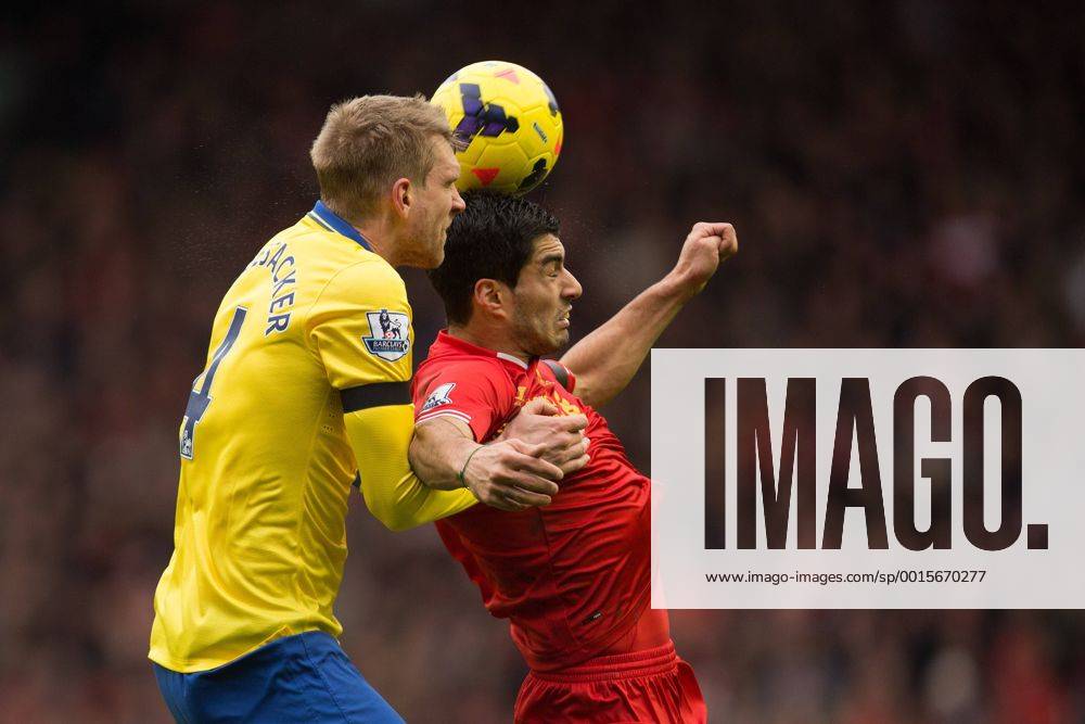 Arsenal s Per Mertesacker and Luis Suarez of Liverpool contest a header - Liverpool vs. Arsenal - Barclays Premier League - Anfield - Liverpool - 08 02 2014 Pic Philip Oldham Sportimage .