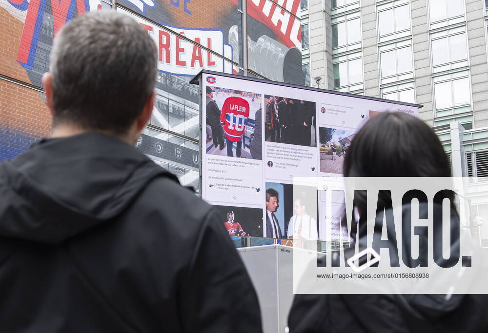 People look up at a screen displaying messages of condolences and memories for Montreal Canadiens legend Guy Lafleur outside the Bell Centre in Montreal, Saturday, April 23, 2022. Lafleur passed away Friday at the age of 70. Montreal Canada - ZUMAc35_ 20220423_zaf_c35_018