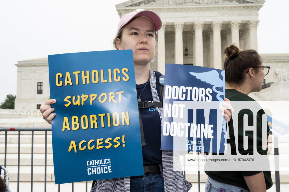 Woman with signs saying Catholics suppport abortion access! and Doctors not doctrine at an abortion related demonstration in front of the Supreme Court. Washington United States - ZUMAb161 20220503_zap_b161_039