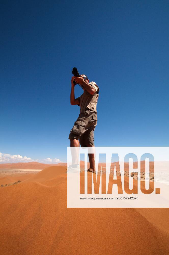 Photographer taking outdoor photos , 2057157.jpg, alone, background, camera, caucasian, desert, digital, equipment, hand, hobby, holding, human, job, journalist, lens, man, namibia, occupation, outdoor, people, person, photo, photograph, photographic, photographing, photography, portrait, professional, sand, shadow, shooting, shot, single, snapshot, sossusvlei, thirsty, top, verticality, winner, winning, young, zoom,