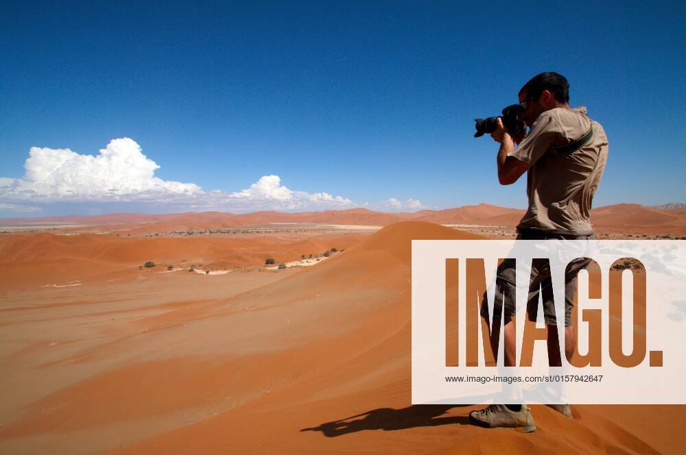 Photographer taking outdoor photos , 2057919.jpg, alone, background, camera, caucasian, desert, digital, equipment, hand, hobby, holding, human, job, journalist, lens, man, namibia, occupation, outdoor, people, person, photo, photograph, photographic, photographing, photography, portrait, professional, sand, shadow, shooting, shot, single, snapshot, sossusvlei, thirsty, top, verticality, winner, winning, young, zoom,