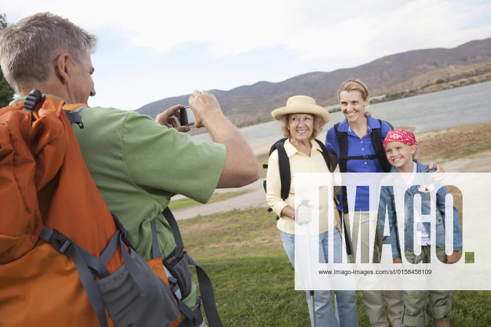 Man photographhs a mother daughter and grand-daughter at lakeside together, model released, , property released, , 10124366.jpg, Outdoors,Day,Standing,Casual Clothing,people,Child,Girl,Women,Man,Hobbies,leisure activity,Photographing,Lake,Backpack,Caucasian,outside,taking a picture,four people,Three Generational family,Outdoor Activity, California