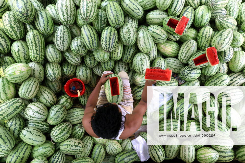 A vendor is selling watermelons in the scorching heat of summer. Tongi Bangladesh - ZUMAk174 20220508_zip_k174_001