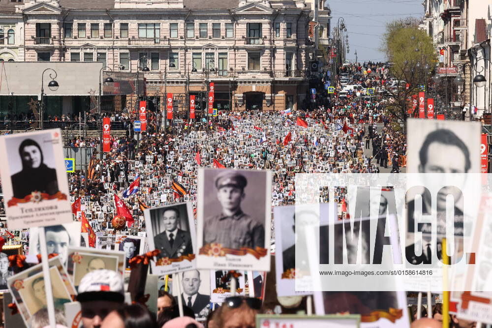 VLADIVOSTOK, RUSSIA â€“ MAY 9, 2022: People holding photographs of their relatives who fought against Nazi Germany in WWII take part in an Immortal Regiment procession marking the 77th anniversary of Allied Victory in WWII. Yuri Smityuk TASS TS1304C4