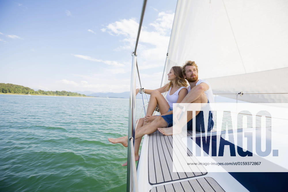 Young couple sailing on Chiemsee lake, Bavaria, Germany, 18.02.2019,