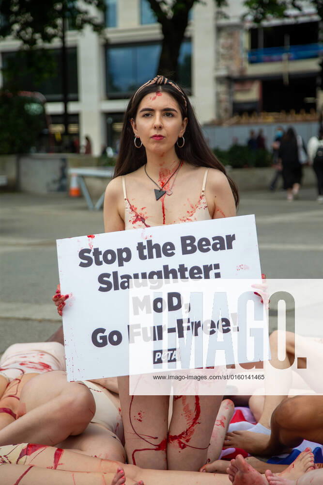PETA supporters wearing little more than bear masks and lying on â€oebloodâ€Â-soaked Union Jack flags will held a bloody â€oedie-in†at Marble Arch to protest the UK Ministry of Defenceâ€⠢s (MoD) support of the slaughter of Canadian black bears, whose fur is used to make the caps worn by the Queenâ€⠢s Guard. London United Kingdom - ZUMAs262 20220528_zip_s262_019