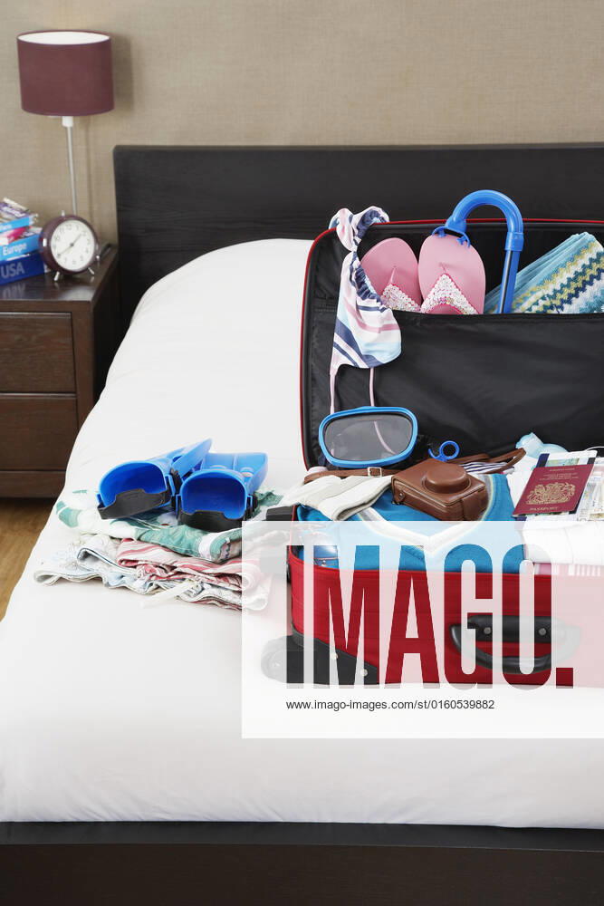 Open suitcase on bed elevated view , 10018270.jpg, Day, Indoors, Bedroom, Vacations, Travel, Bed, Preparation, Tourism, Nobody, Open, clothes, Red, Holidays, Order, Luggage, inside, Suitcase, Packing, Summer Clothing, close up, Hotel Room, Beachwear, Snorkelling Equipment, Studio,